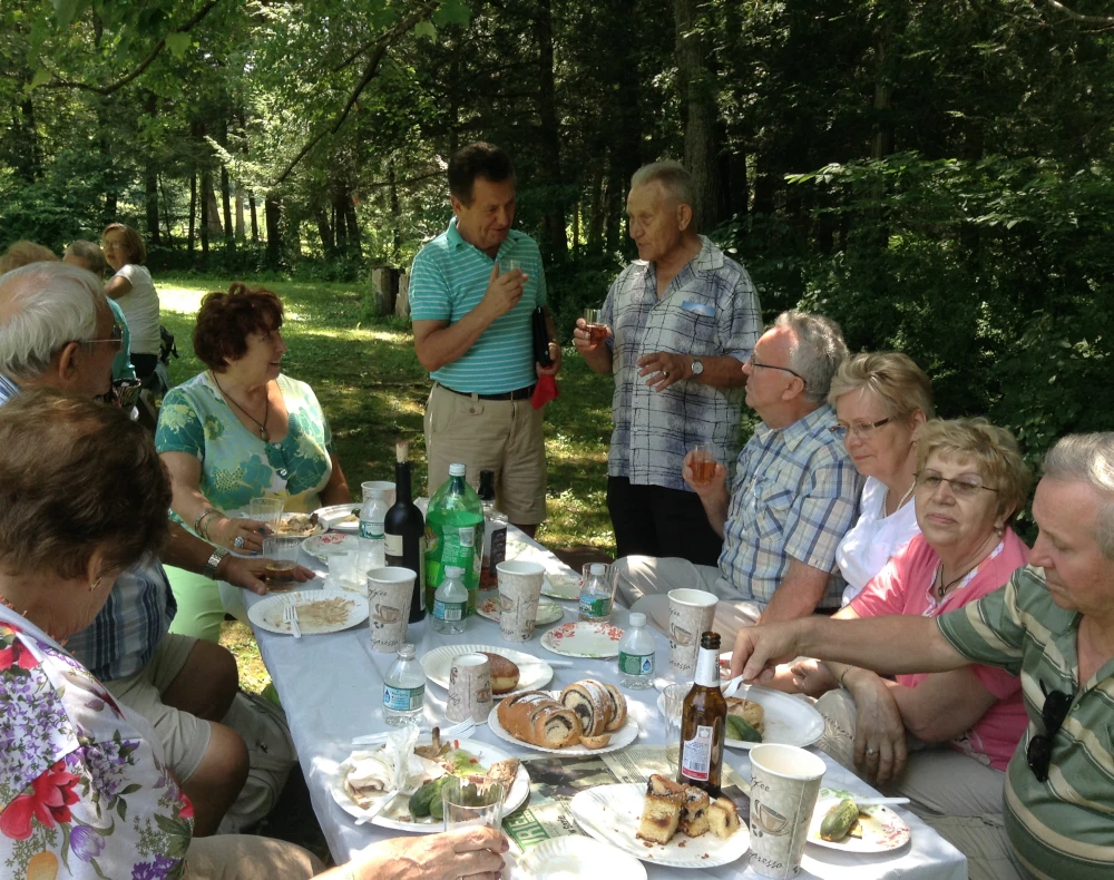 Families and friends enjoying the summer picnic outdoors